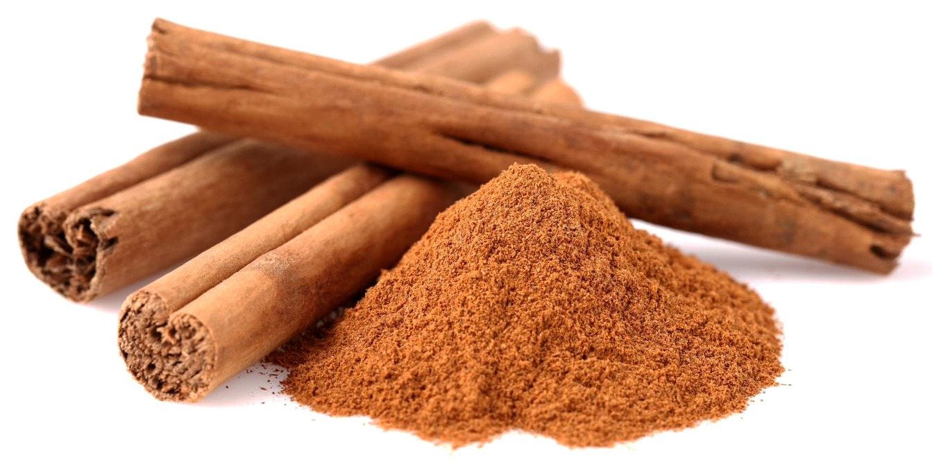 Cinnamon sticks beside a mound of ground cinnamon
