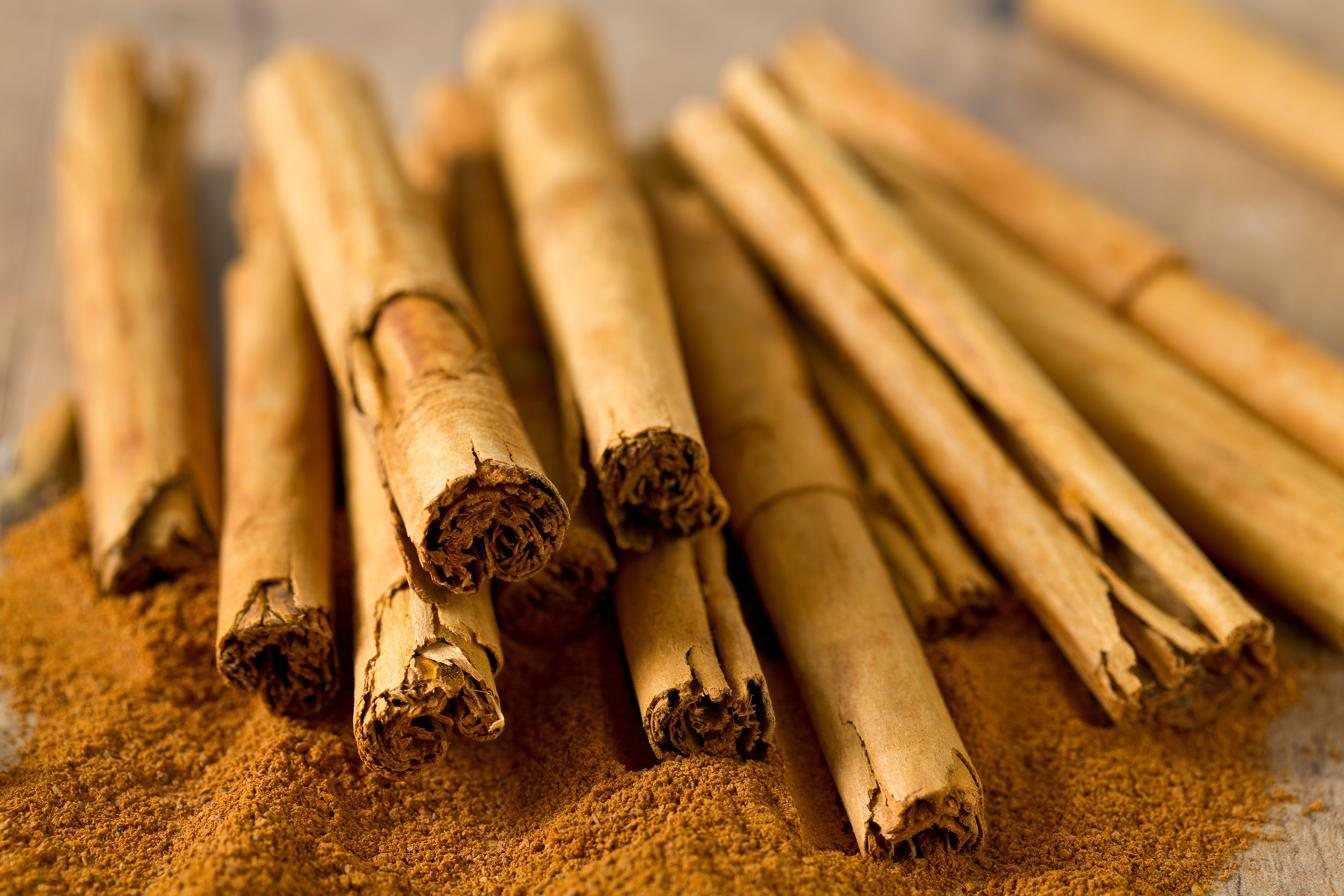 A pile of cinnamon sticks resting on ground cinnamon