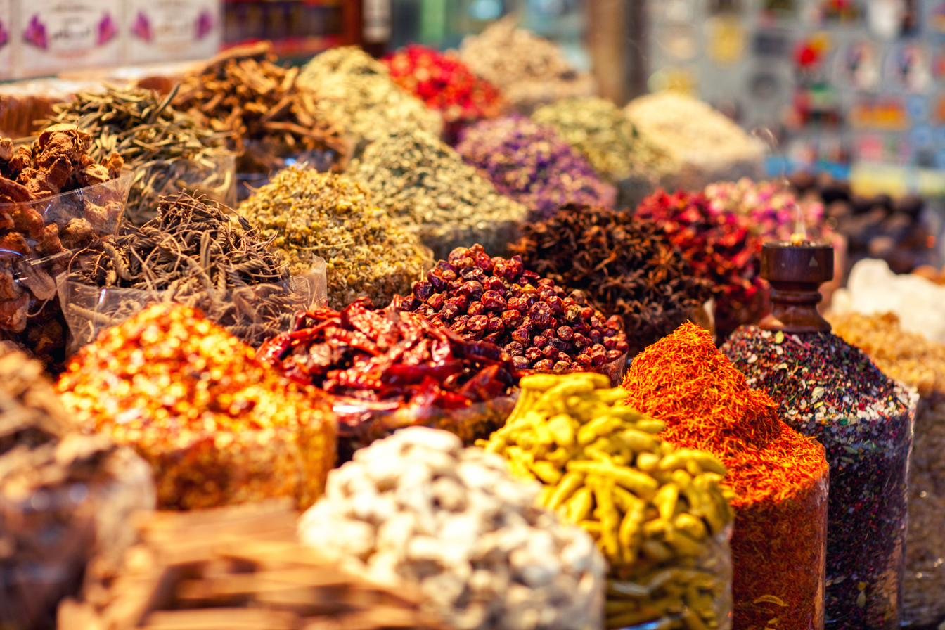 A spice market stall heaped with colorful spices